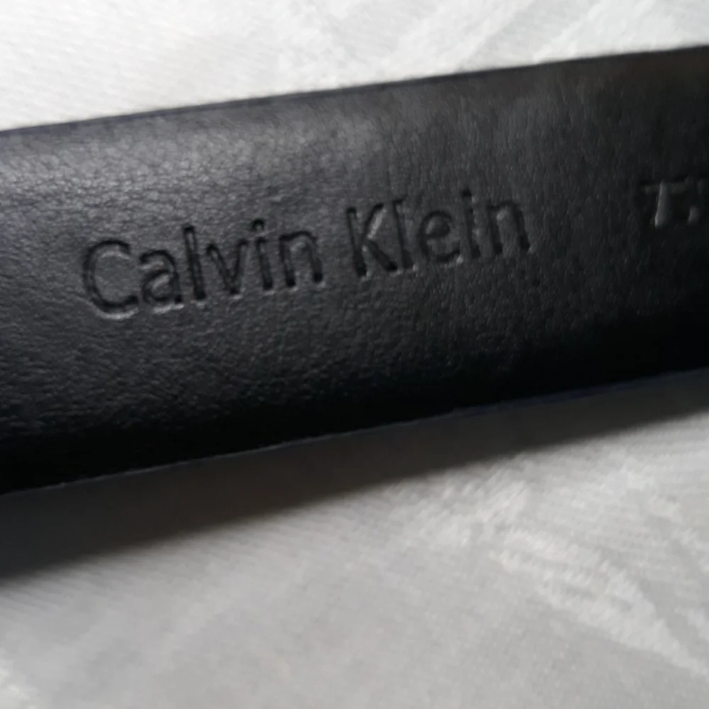 Calvin Klein dark blue leather belt. 34 inches long